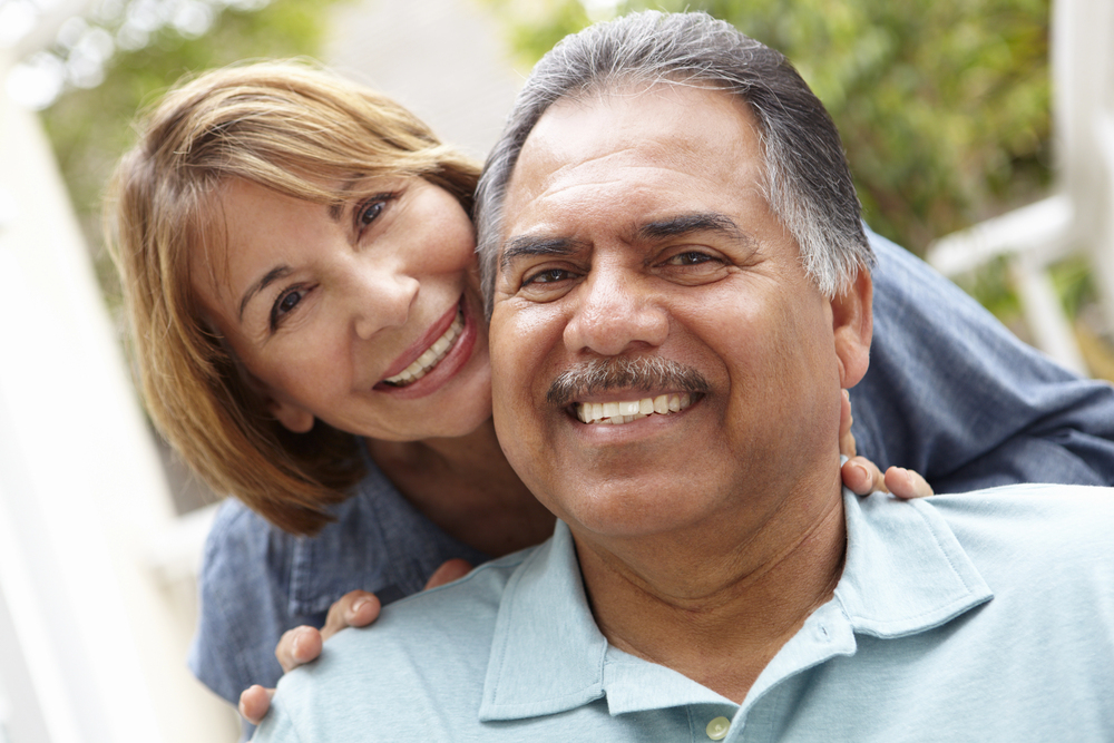 older hispanic couple smiling